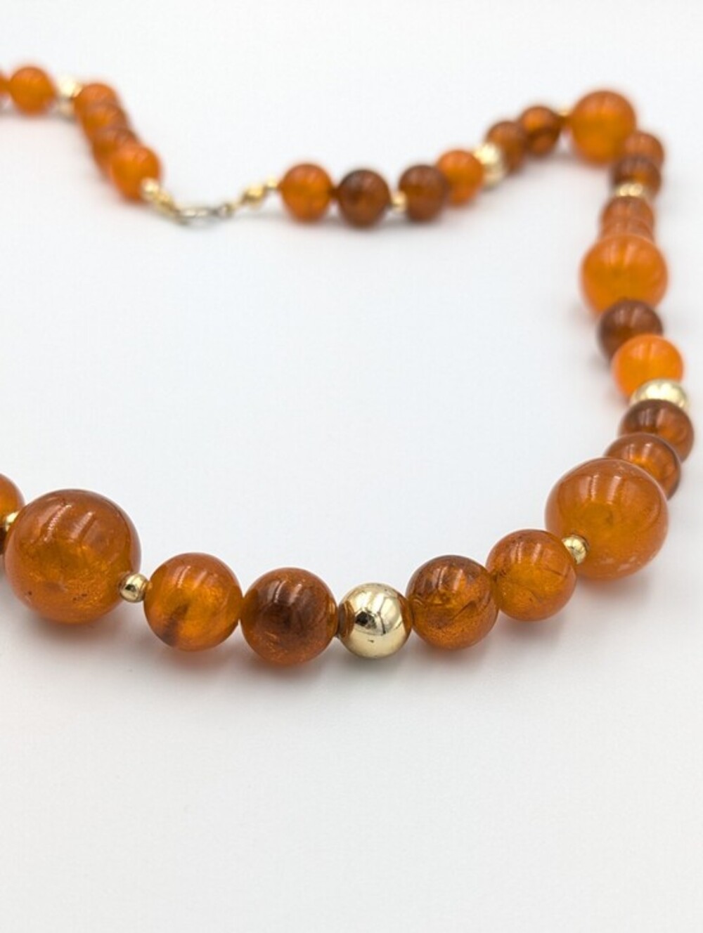 Vintage gold tone and orange plastic beaded single strand necklace
